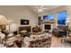 Bright living room with a fireplace, large windows, and comfortable seating at 20510 Oakbrook Ln, Parker, CO 80138