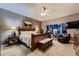 Calming main bedroom with a large window, a ceiling fan, and a seating area at 20510 Oakbrook Ln, Parker, CO 80138