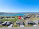 Aerial view of the property showcasing its location, neighborhood, nearby lake, and mountain views at 32 Latigo Pl, Littleton, CO 80123