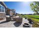 Spacious backyard with a stone fire pit, comfortable seating, and well-maintained landscaping at 32 Latigo Pl, Littleton, CO 80123