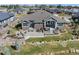 Serene backyard featuring a stone patio with fire pit, lush lawn, and comfortable outdoor seating at 32 Latigo Pl, Littleton, CO 80123