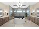 This modern bathroom features dual vanities, a soaking tub, and a large shower at 32 Latigo Pl, Littleton, CO 80123