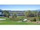 Scenic view of the neighborhood community park with walking paths, green spaces, and distant mountain views at 32 Latigo Pl, Littleton, CO 80123