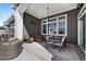 Stylish covered patio featuring comfortable seating, dining area, ceiling fan, and heater for year-round enjoyment at 32 Latigo Pl, Littleton, CO 80123
