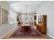 Elegant dining room with chandelier, large windows, and hardwood flooring at 32 Latigo Pl, Littleton, CO 80123