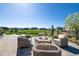 Outdoor fire pit with comfortable seating, perfect for enjoying the beautiful backyard and lush green space at 32 Latigo Pl, Littleton, CO 80123