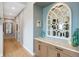 A hallway showcases a decorative mirror above built-in cabinets with granite countertop at 32 Latigo Pl, Littleton, CO 80123