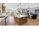 Spacious kitchen with island and breakfast bar opening up to the living room and dining area at 32 Latigo Pl, Littleton, CO 80123