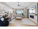 Bright, open-concept living room with large windows and a cozy fireplace at 32 Latigo Pl, Littleton, CO 80123