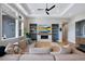 Inviting living room boasts built-in shelving, modern fireplace, plush seating, and abundant natural light at 32 Latigo Pl, Littleton, CO 80123