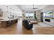 Open concept living room featuring a fireplace, built-in shelves, and oversized windows at 32 Latigo Pl, Littleton, CO 80123