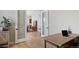 Bright office space with a large desk, modern decor, and access to other areas of the home at 32 Latigo Pl, Littleton, CO 80123