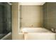 Modern bathroom features include a bathtub, shower with glass doors, and sleek tile at 1133 14Th St # 2110, Denver, CO 80202