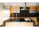 Gourmet kitchen with sleek cabinets, black countertops, stainless steel appliances, and pendant lights at 1133 14Th St # 2110, Denver, CO 80202