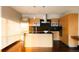 Contemporary kitchen featuring stainless steel appliances, island with sink, wooden cabinets, and wood floors at 1133 14Th St # 2110, Denver, CO 80202