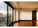 Bright, modern room featuring hardwood floors and expansive windows with a city view at 1133 14Th St # 2110, Denver, CO 80202