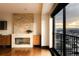 Bright living room featuring a stone fireplace, wood floors, and balcony with city views at 1133 14Th St # 2110, Denver, CO 80202