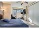 Bright bedroom features an entertainment area, closet, desk and a comfortable bed at 1583 Grove St # 5, Denver, CO 80204