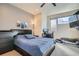 Comfortable bedroom featuring a plush bed, dark furniture, and a well-lit workspace at 1583 Grove St # 5, Denver, CO 80204
