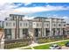 Modern townhomes with balconies, roof decks, brick accents, and manicured landscaping offer luxury living at 1583 Grove St # 5, Denver, CO 80204