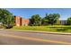 Historic school building with brick facade, surrounded by lush greenery, showcasing a picturesque setting at 1583 Grove St # 5, Denver, CO 80204