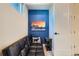 Cozy sitting area features a black leather sofa and a striking mountain print on a blue accent wall at 1583 Grove St # 5, Denver, CO 80204