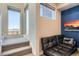 Bright sitting area with natural light from clerestory windows, complemented by a leather sofa and blue accent wall at 1583 Grove St # 5, Denver, CO 80204