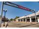 Charming Edgewater street view with vintage street lamps, local shops, restaurants, and a clear blue sky above at 1583 Grove St # 5, Denver, CO 80204