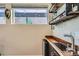 Stylish wet bar features wooden countertops, open shelving, and ample natural light from a nearby window at 1583 Grove St # 5, Denver, CO 80204