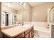 Bathroom features a tub, shower, white tile and a large mirror at 10176 Park Meadows Dr # 2403, Lone Tree, CO 80124