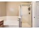 Bathroom featuring a glass shower, tub, and white tiled walls at 10176 Park Meadows Dr # 2403, Lone Tree, CO 80124