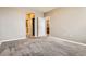 Bedroom features neutral walls, gray carpet, and doors to the closet and bathroom at 10176 Park Meadows Dr # 2403, Lone Tree, CO 80124