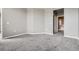 Bedroom features gray carpet, neutral walls, and an open bathroom entry at 10176 Park Meadows Dr # 2403, Lone Tree, CO 80124