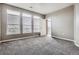 Bedroom featuring gray carpet, neutral walls, and three large windows with blinds at 10176 Park Meadows Dr # 2403, Lone Tree, CO 80124
