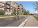Apartment building with balconies, and manicured lawn on a wet day, shot from street level at 10176 Park Meadows Dr # 2403, Lone Tree, CO 80124