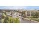 A view of the building's exterior with parking and greenery surrounding the property at 10176 Park Meadows Dr # 2403, Lone Tree, CO 80124