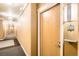 Hallway with apartment entrance and unit number, featuring neutral colors and good lighting at 10176 Park Meadows Dr # 2403, Lone Tree, CO 80124
