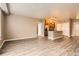 Open concept with kitchen island, stainless appliances and wood grain laminate at 10176 Park Meadows Dr # 2403, Lone Tree, CO 80124