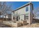 Exterior view of home with a backyard featuring raised garden beds at 12144 Newport Dr, Brighton, CO 80602