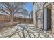 Private backyard with a concrete patio, partial fencing, and mature trees at 12144 Newport Dr, Brighton, CO 80602