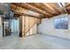 Unfinished basement with exposed beams, concrete floor and window at 12144 Newport Dr, Brighton, CO 80602