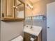 Bathroom vanity with sink, mirror, and natural light at 12144 Newport Dr, Brighton, CO 80602