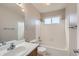 Bright bathroom with white tiled shower, tub, and vanity with large mirror at 12144 Newport Dr, Brighton, CO 80602