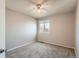 Cozy carpeted bedroom featuring a ceiling fan and a window for natural light at 12144 Newport Dr, Brighton, CO 80602