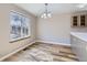 Dining area with large windows and updated chandelier at 12144 Newport Dr, Brighton, CO 80602