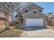 Charming two-story home with brick accents, a well-maintained lawn, and a two-car garage at 12144 Newport Dr, Brighton, CO 80602