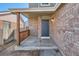 Inviting front porch with brick accents and wooden railings, offering a warm welcome to the home at 12144 Newport Dr, Brighton, CO 80602