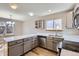 Well-lit kitchen features stainless appliances, updated countertops and hardware, and hardwood style floors at 12144 Newport Dr, Brighton, CO 80602