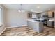 Open concept kitchen with breakfast bar adjacent to dining area at 12144 Newport Dr, Brighton, CO 80602