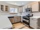 Well-equipped kitchen with stainless steel appliances, light countertops, and ample cabinet space at 12144 Newport Dr, Brighton, CO 80602